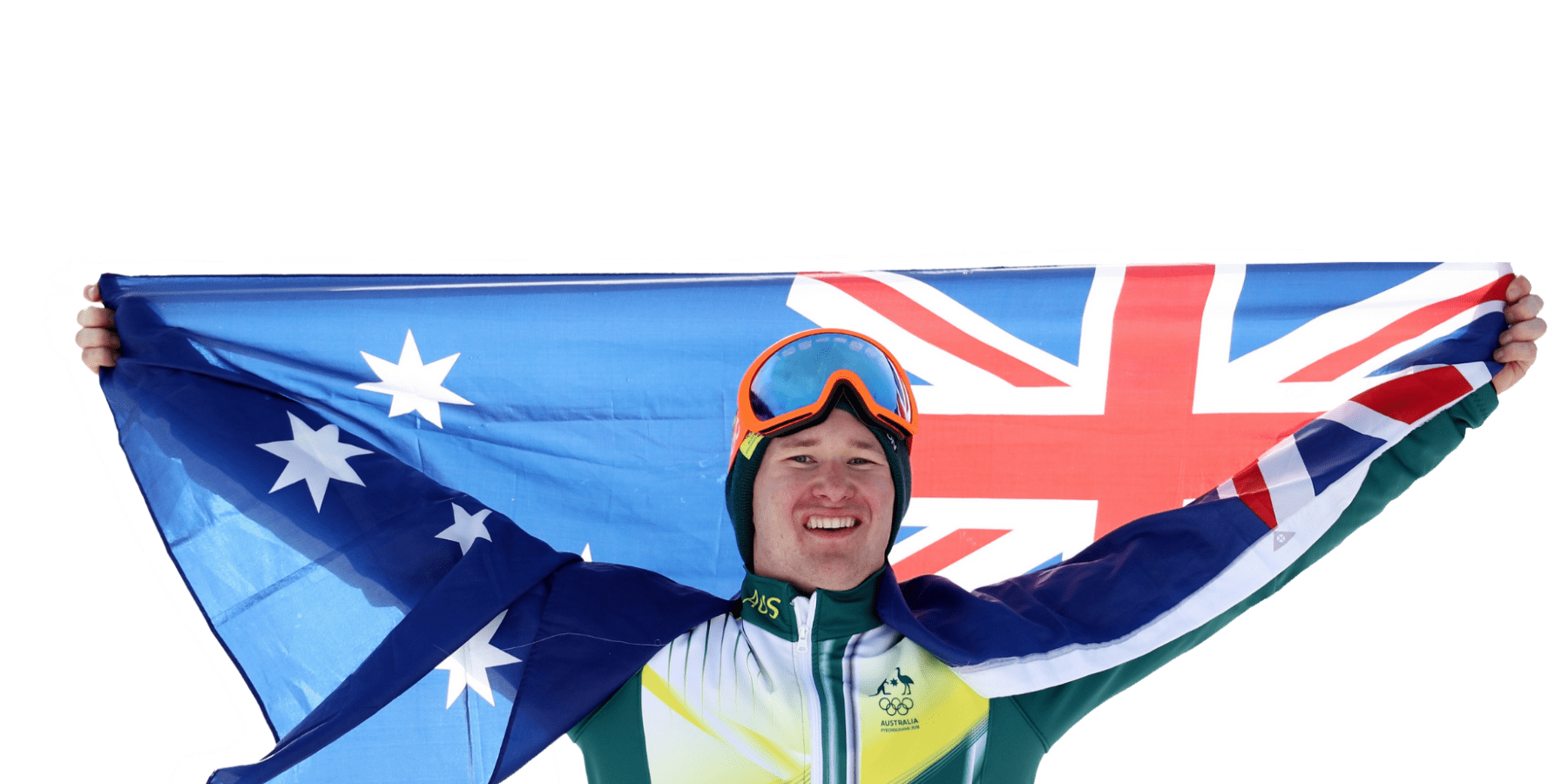 A man in ski gear and goggles with an australian flag behind him.