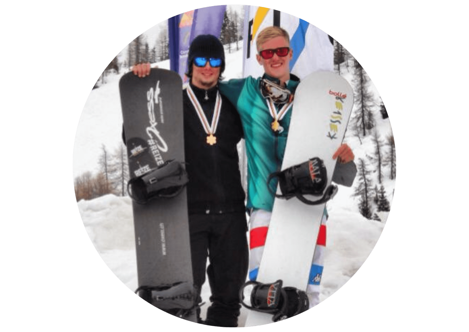 Two people holding snowboards in the snow.